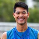 Portrait of Jian Li, a marathon runner, smiling confidently after a race